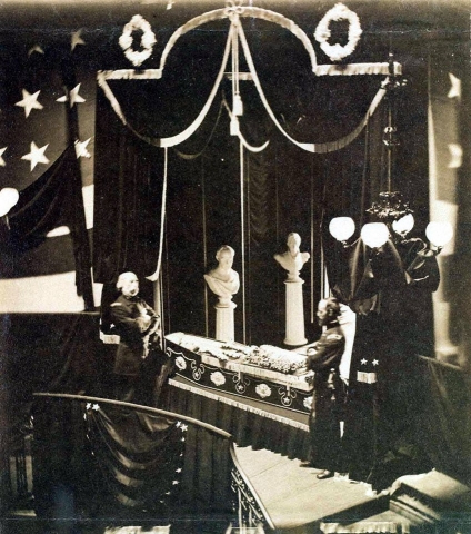 President Abraham Lincoln lies in state at the top of a circular staircase beneath the rotunda of the City Hall.